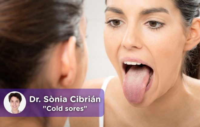 Woman looking in the mirror at her tongue with cold or canker sores.